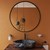 Orange Bathroom with Circular Mirror
