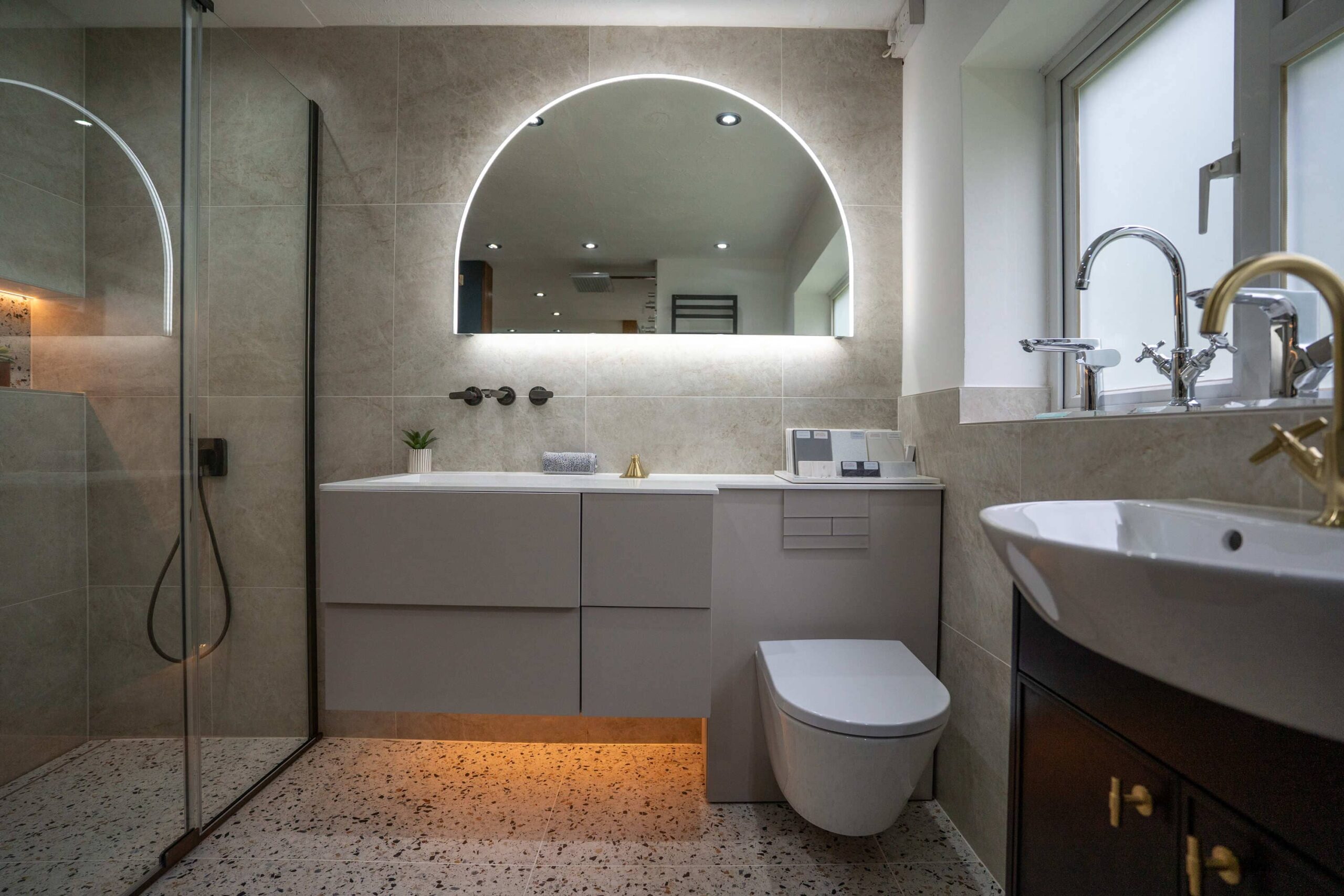 Contemporary bathroom with a walk-in shower, wall-hung toilet, floating vanity and illuminated mirror